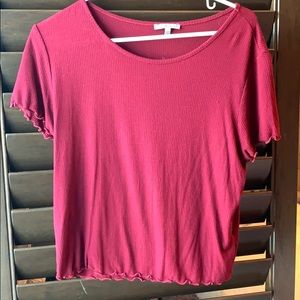 A maroon shirt with detailed edges.